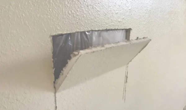 Section of drywall cut open to check for hidden mold